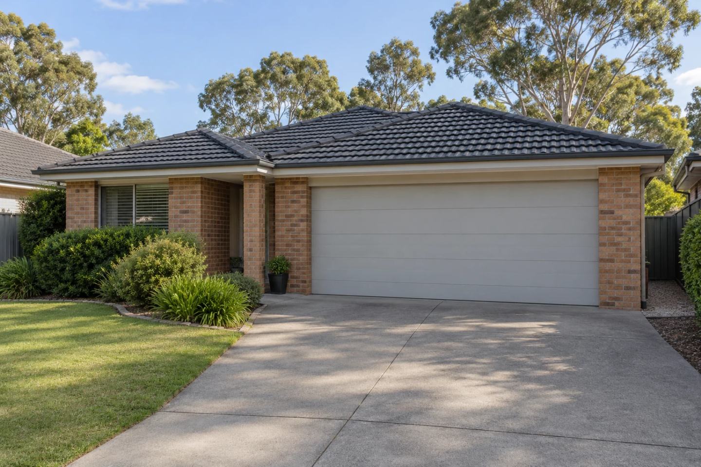 Brick suburban home with an attached garage and a closed garage door.